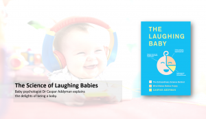 Laughing baby in background with book in foreground