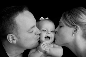mommy-and-daddy-kissing-baby-small